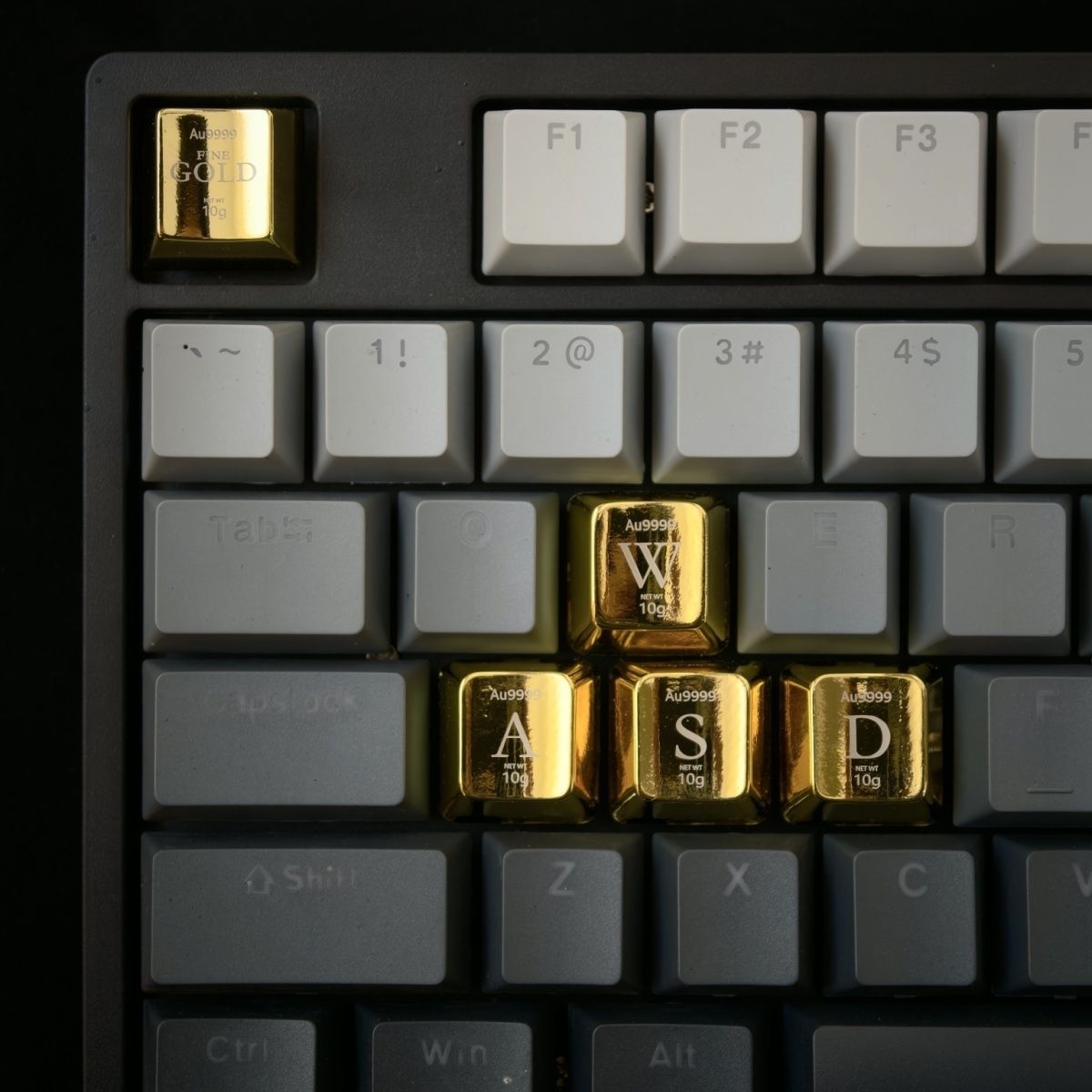 Close up of a custom logo engraved on a shiny gold zinc alloy keycap Cherry profile