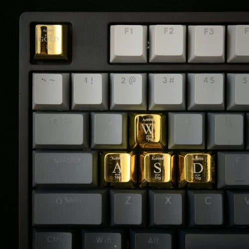 Close up of a custom logo engraved on a shiny gold zinc alloy keycap Cherry profile