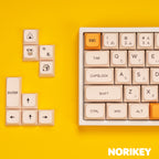 Honey Milk cute PBT keycap set on mechanical keyboard showing beige and yellow colorway from side angle